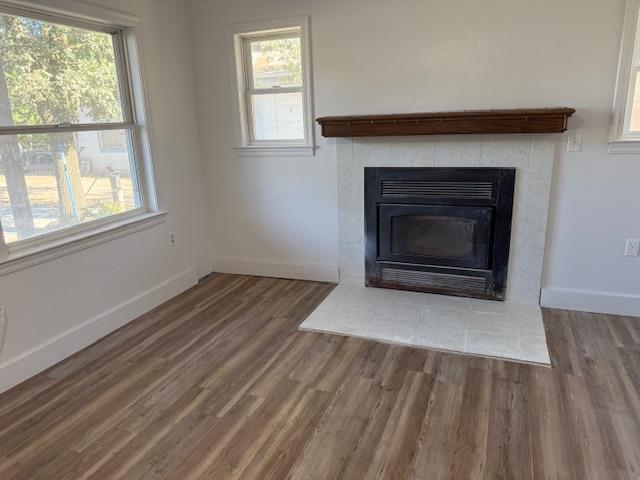 9537 Wamble Road Oakdale, CA 95361 - Photo 9 of 29 an empty room with wooden floor fireplace and windows