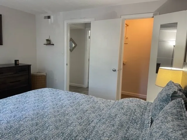 a bedroom with a bed and a dresser