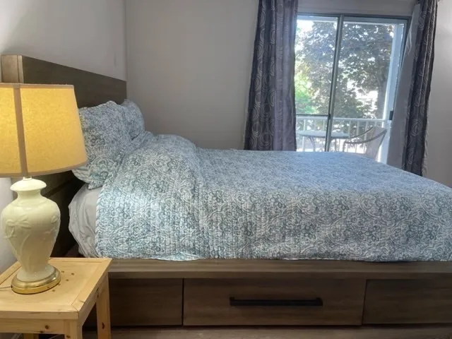 a bedroom with a bed and window