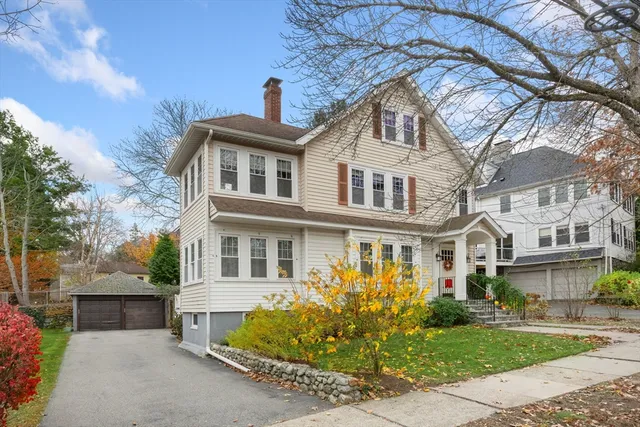 a front view of a house with a garden