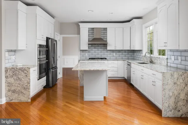 a bathroom with a toilet sink vanity and mirror