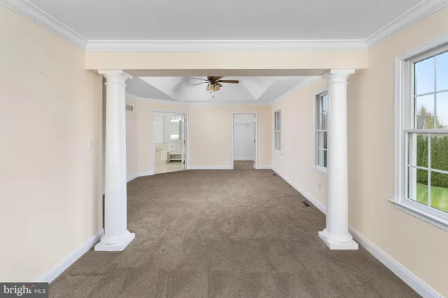 a view of empty room with ceiling fan