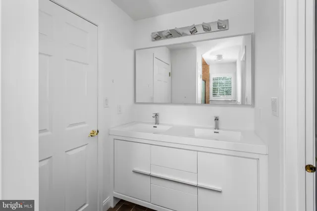 a aerial view of a house next to a big yard and large trees