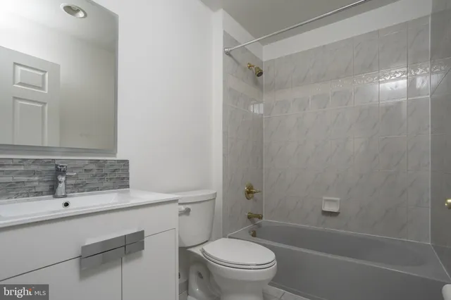 a view of a big house with a big yard and large trees