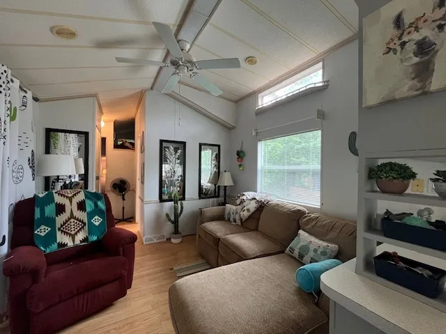 a view of a hallway with bathroom and wooden floor