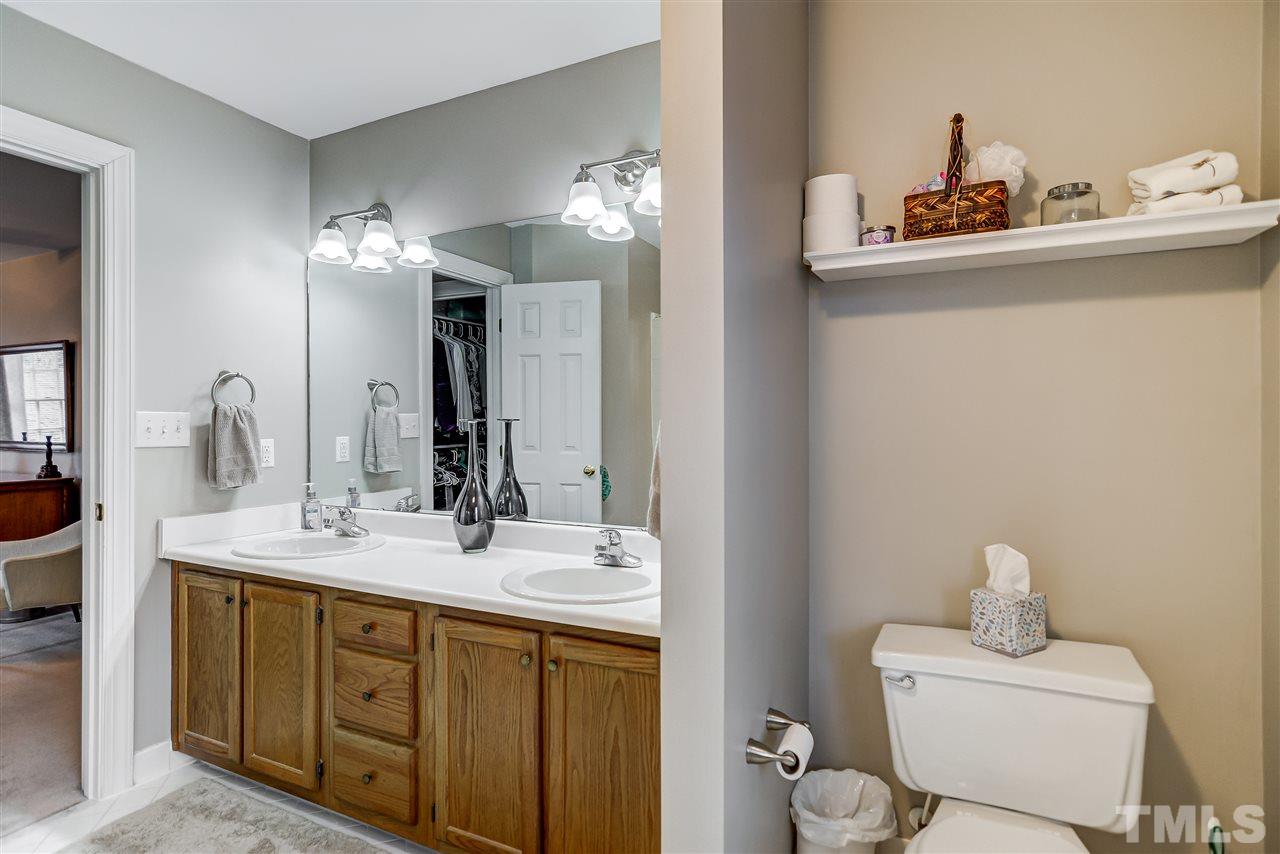 5121 Celbridge Place Raleigh, NC 27613 - Photo 12 of 22 a bathroom with a sink and a mirror
