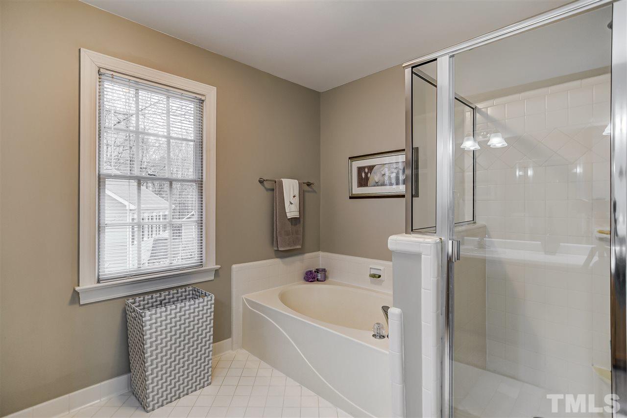 5121 Celbridge Place Raleigh, NC 27613 - Photo 13 of 22 a bathroom with a bathtub and a shower