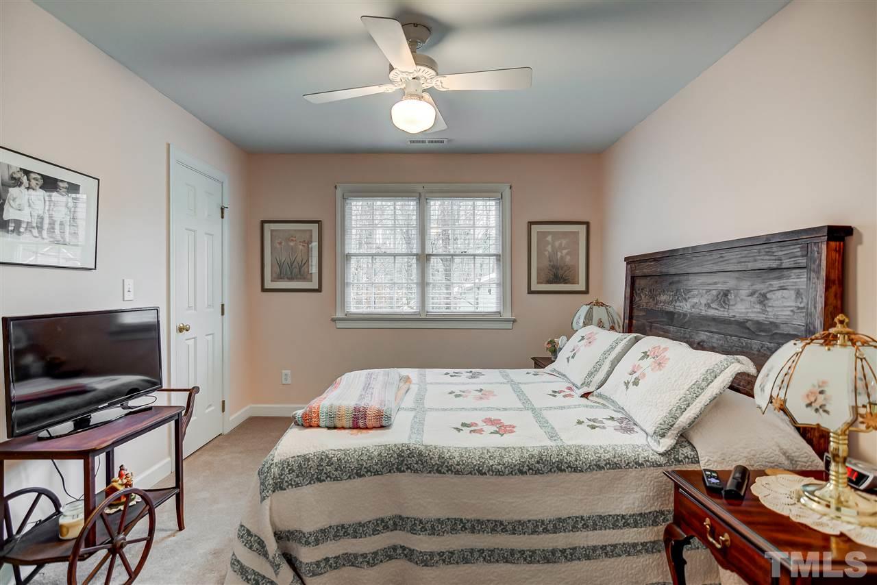 5121 Celbridge Place Raleigh, NC 27613 - Photo 15 of 22 a bedroom with a bed and a flat screen tv