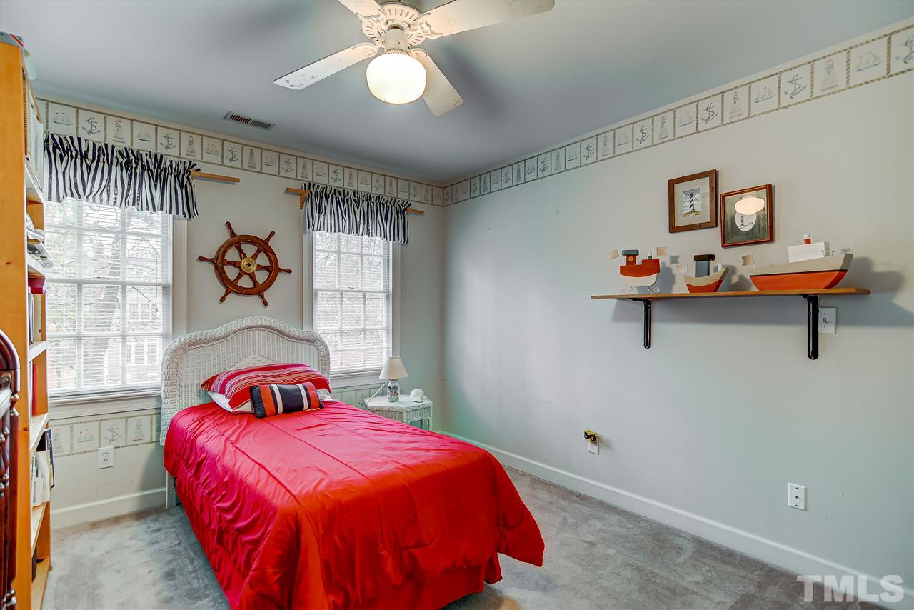 5121 Celbridge Place Raleigh, NC 27613 - Photo 16 of 22 a bedroom with a bed and a painting on the wall
