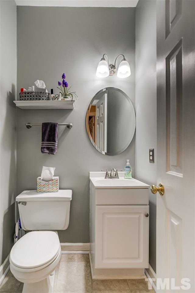 5121 Celbridge Place Raleigh, NC 27613 - Photo 10 of 22 a bathroom with a toilet sink and mirror