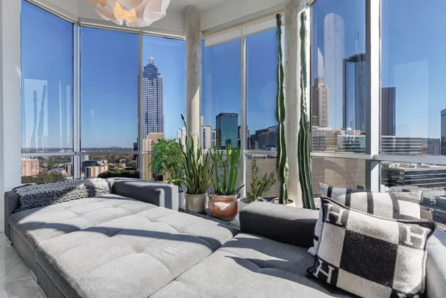 a bedroom with furniture and a large window