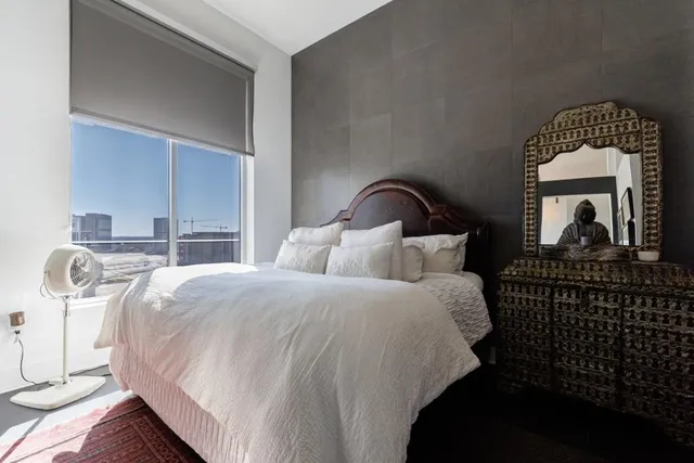 a bedroom with bed and window