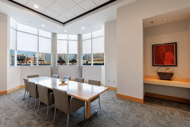 a dining room with furniture a rug and a painting