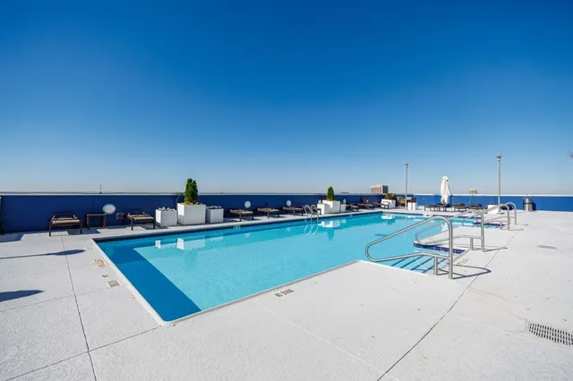 a view of a kitchen with kitchen island and a sink