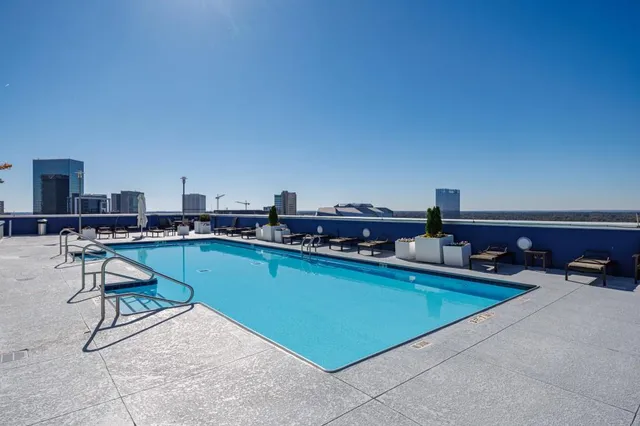 a living room with furniture a flat screen tv and outdoor seating