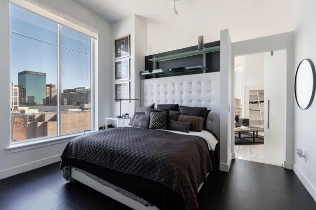 a bedroom with a large bed and a window