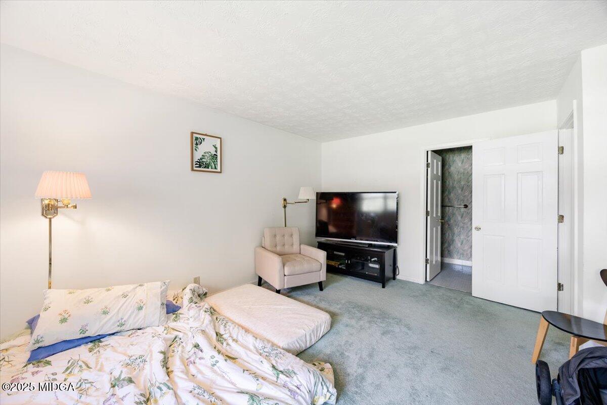 1414 Park Avenue Perry, GA 31069 - Photo 15 of 37 a bedroom with a bed and a flat screen tv
