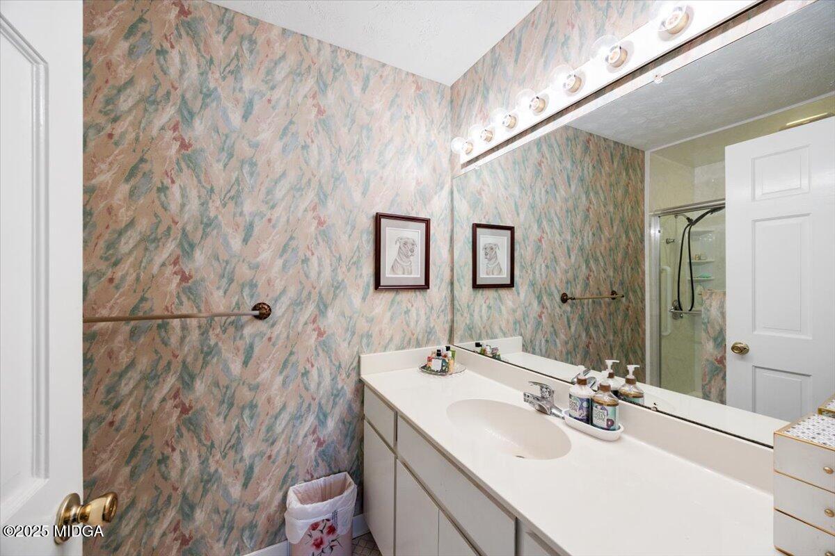 1414 Park Avenue Perry, GA 31069 - Photo 16 of 37 a bathroom with a sink vanity mirror and toilet