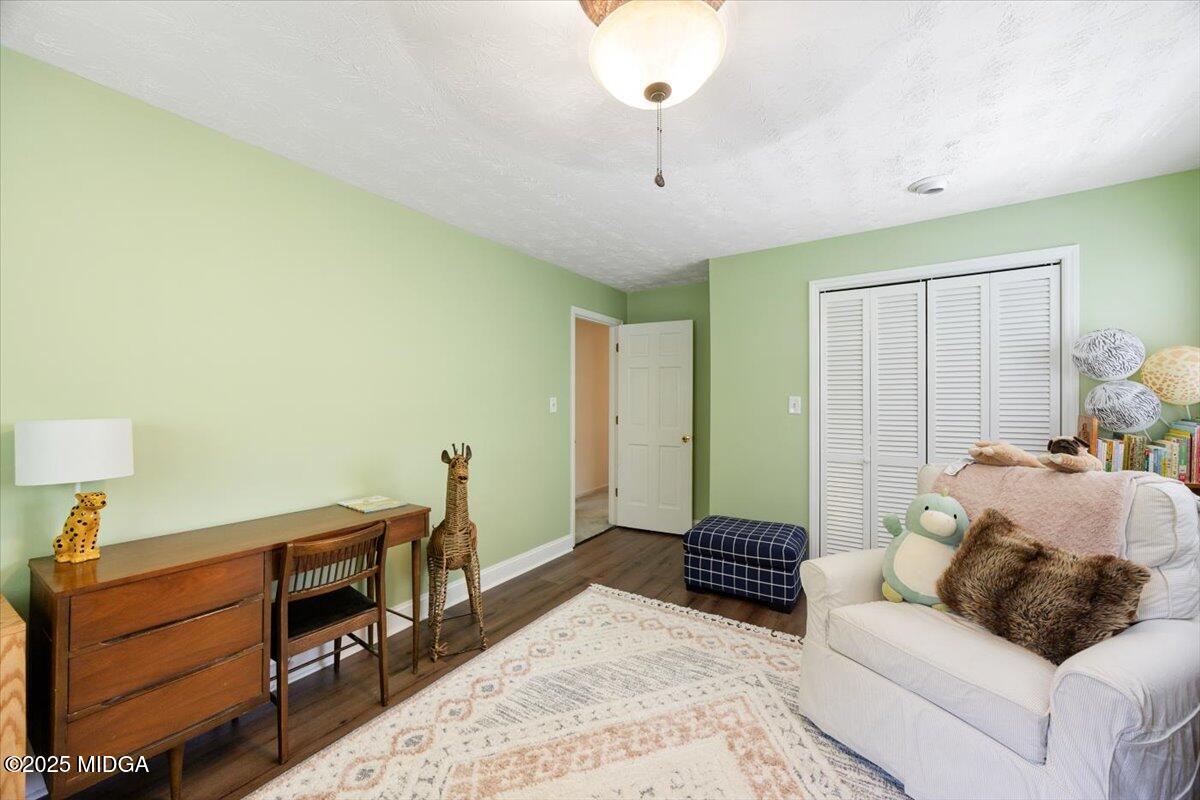 1414 Park Avenue Perry, GA 31069 - Photo 18 of 37 a spacious bedroom with a bed and a chandelier