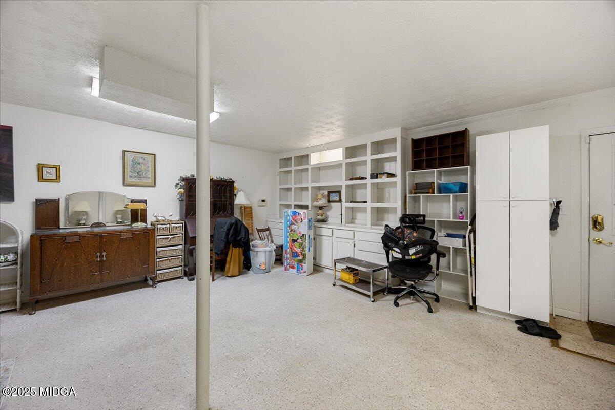 1414 Park Avenue Perry, GA 31069 - Photo 24 of 37 a view of a bedroom with workspace and windows