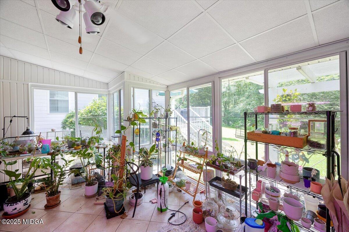 1414 Park Avenue Perry, GA 31069 - Photo 27 of 37 a room with lots of potted plants and large windows