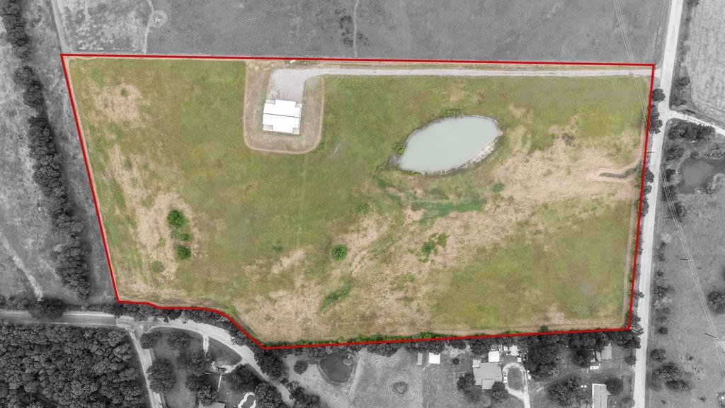 1161 Alsdorf Road Ennis, TX 75119 - Photo 1 of 28 Expansive parcel featuring a large pond, perimeter fencing, and a building structure
