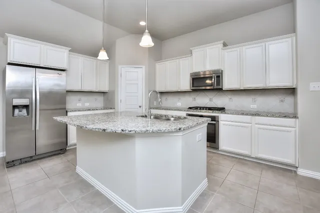 a kitchen with a stove and a sink
