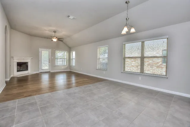 a large kitchen with stainless steel appliances kitchen island granite countertop a stove a sink a refrigerator and a granite counter tops with white cabinets