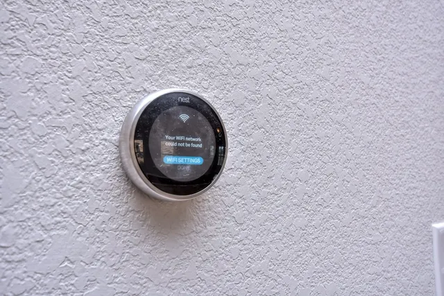 a view of an empty room with a window and fireplace