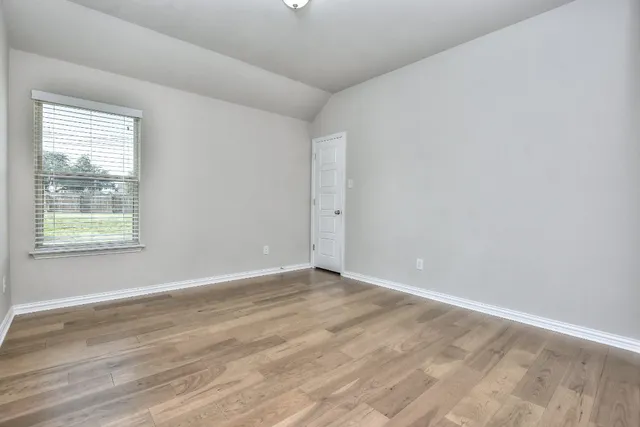 a view of an empty room and glass door