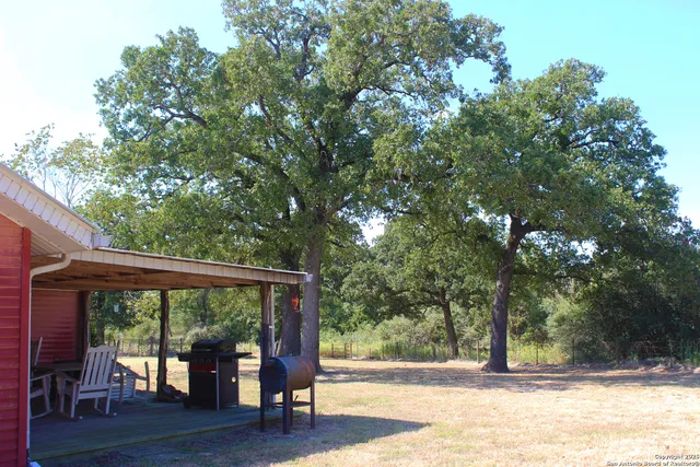 a view of outdoor space with deck and trees