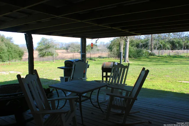 a view of a porch with furniture and wooden floor