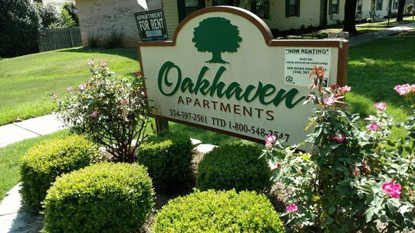 a sign that is sitting in front of flowers