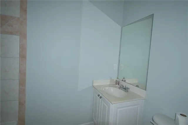 a bathroom with a sink toilet and a mirror