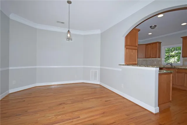 a view of a kitchen with wooden floor and a sink
