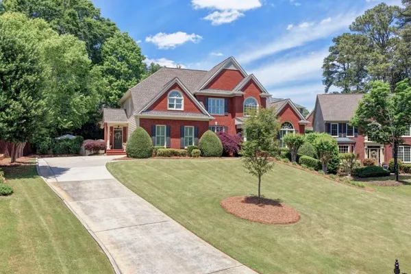 a front view of a house with a yard