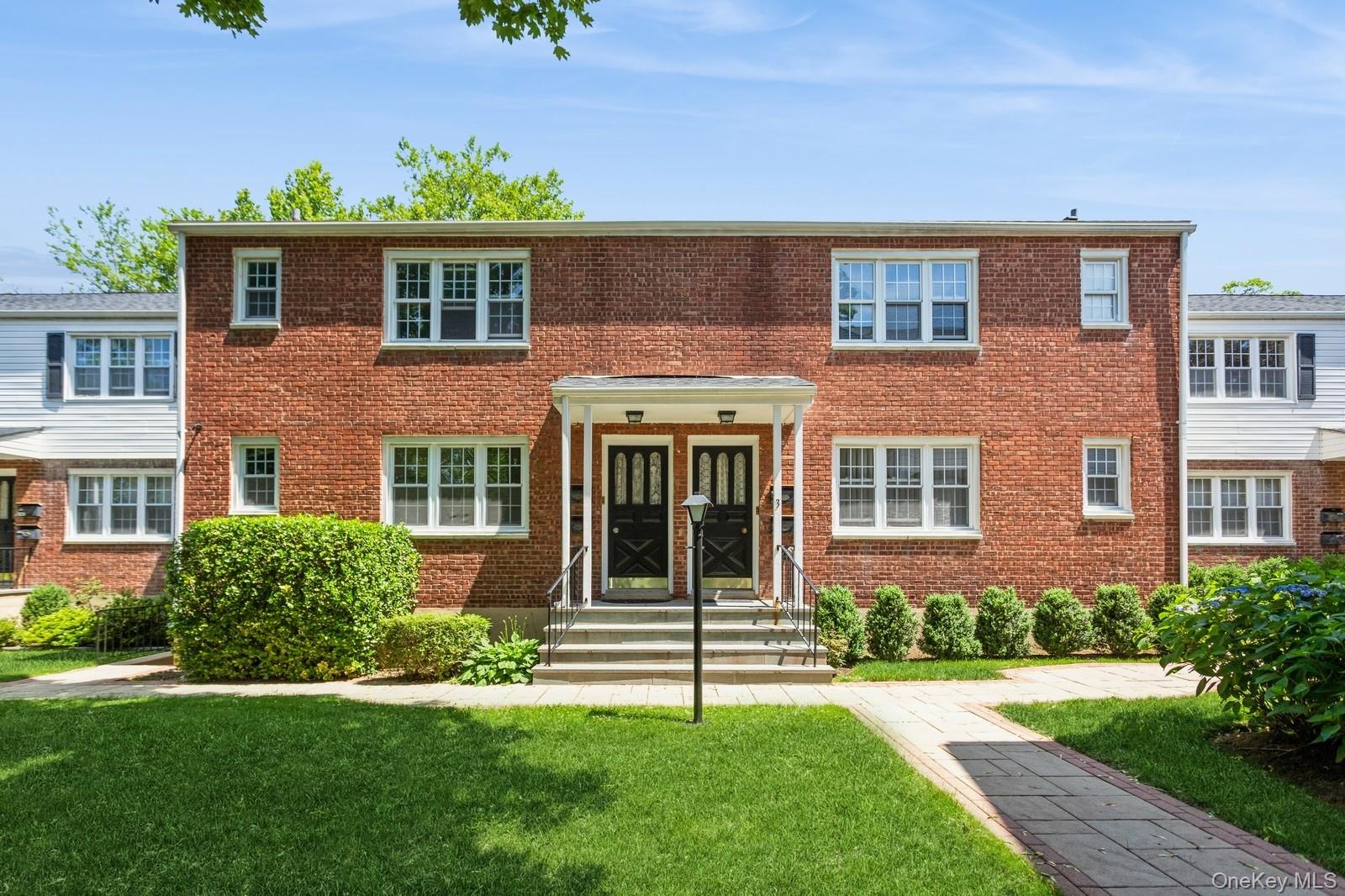 51 Cross Street, Unit 3A Yonkers, NY 10708 - Photo 1 of 17 View of front of property with a front yard and brick siding