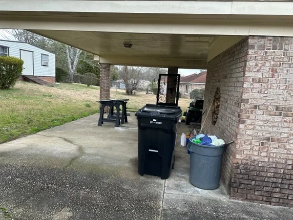 a view of a chairs and table in the backyard