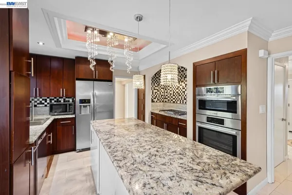 a kitchen with a sink a stove and a wooden cabinets