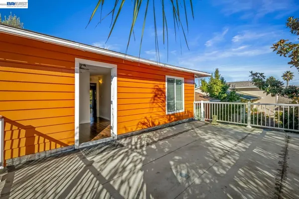 a view of a house with a wooden fence