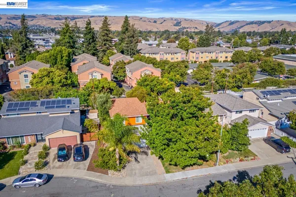 an aerial view of residential houses with outdoor space