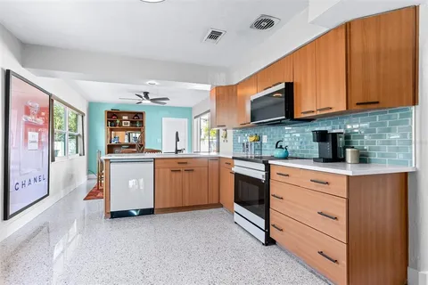 a kitchen with stainless steel appliances granite countertop a stove sink and cabinets