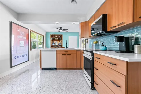 a kitchen with cabinets a sink and appliances