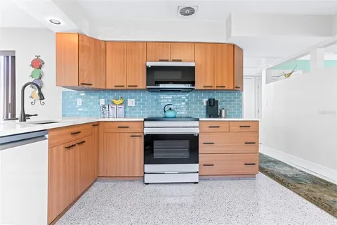 a kitchen with stainless steel appliances a stove microwave and cabinets