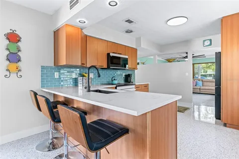 a kitchen with a appliances a sink and a table