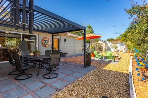 a view of a patio with table and chairs and potted plants
