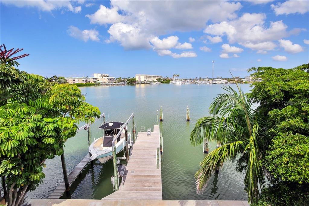 366 145th Avenue Madeira Beach, FL 33708 - Photo 1 of 1 a view of a lake with a table and chairs