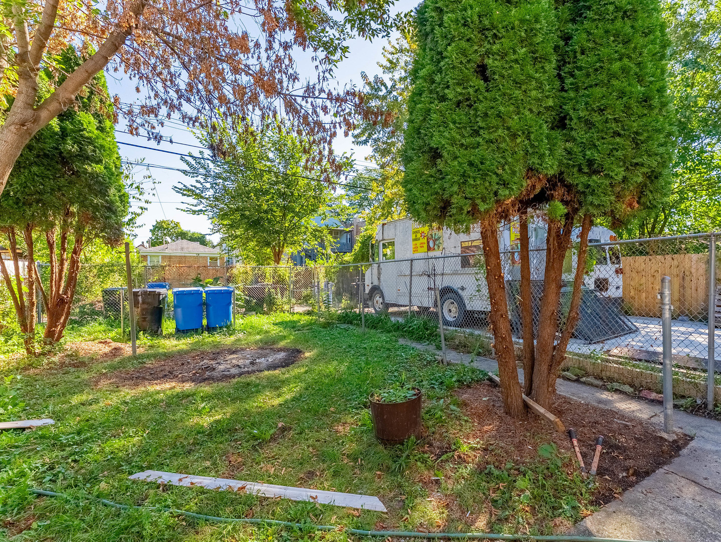 7041 South Throop Street Chicago, IL 60636 - Photo 32 of 36 a view of a backyard with plants and large tree