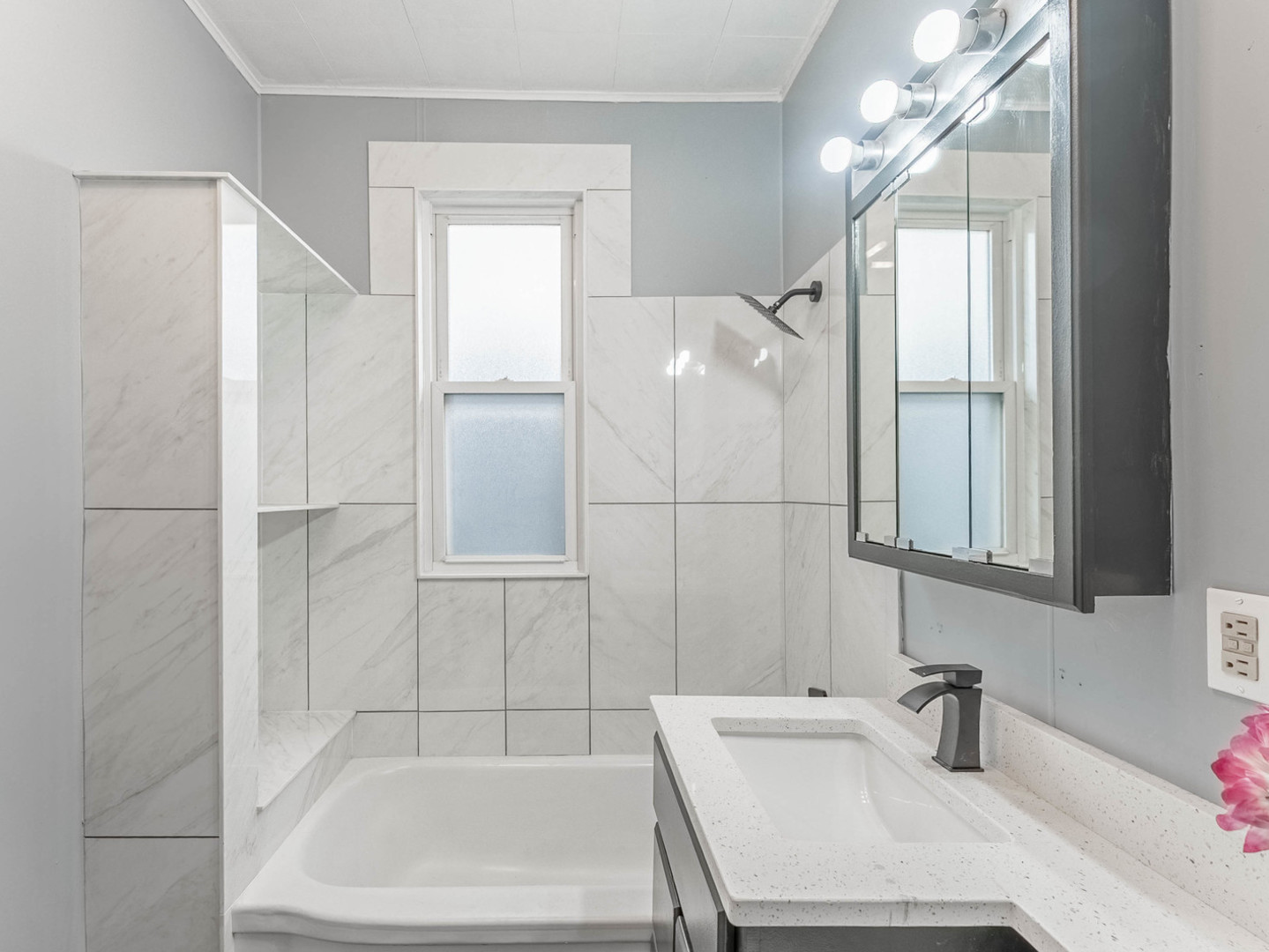 7041 South Throop Street Chicago, IL 60636 - Photo 10 of 36 a bathroom with a sink a mirror and a bathtub