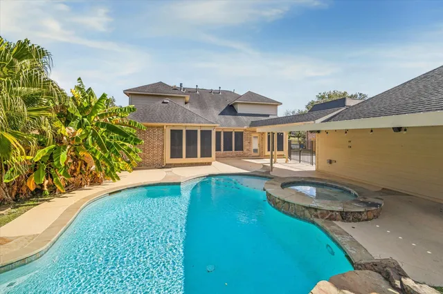 a backyard of a house with table and chairs